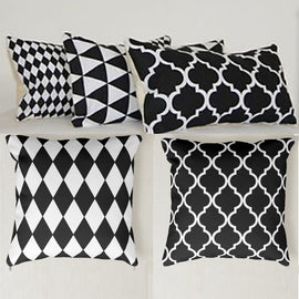 Five black and white cushion covers with assorted geometric patterns.