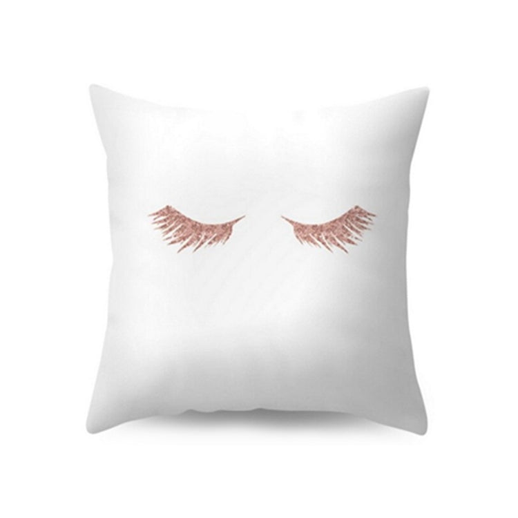 White cushion cover with a rose-toned eyelash illustration.
