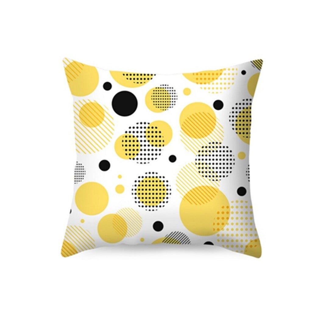 White cushion cover with yellow, grey and black circles.