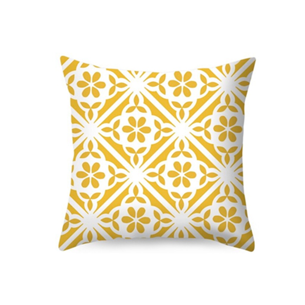 White cushion cover with yellow ornamental floral motifs.
