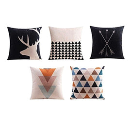 Five cushion covers with black, blush and cream geometric and deer designs.
