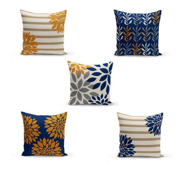 Five cushion covers with navy, mustard and cream botanical patterns.
