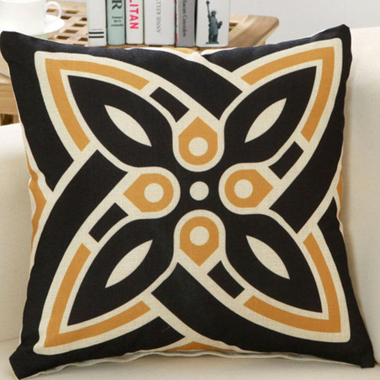 Black cushion cover with a large cream and gold four-petal motif.