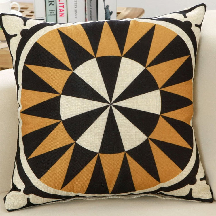 Black, cream and gold cushion cover with a circular starburst pattern.