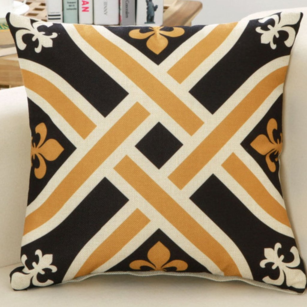 Cushion cover with interlocking black, cream and gold geometric bands.