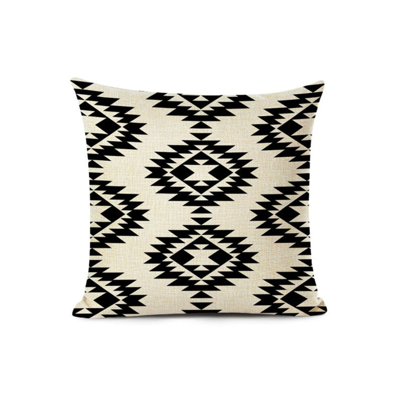 Cream cushion cover with black stepped geometric diamond motifs.