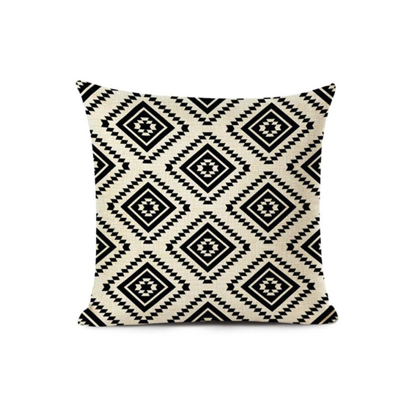 Cream cushion cover with repeating black geometric diamonds.