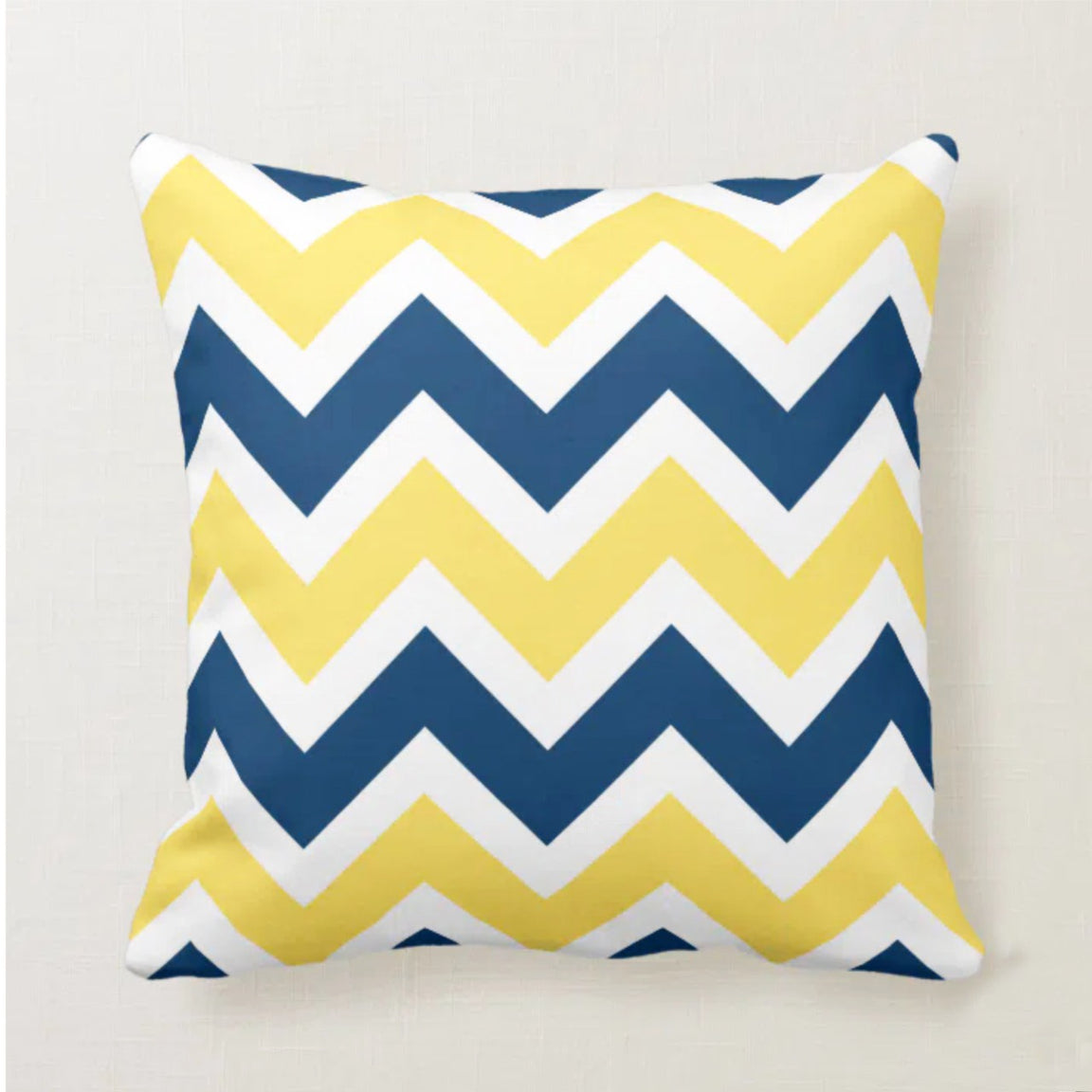 Cushion cover with navy, yellow and white chevrons.