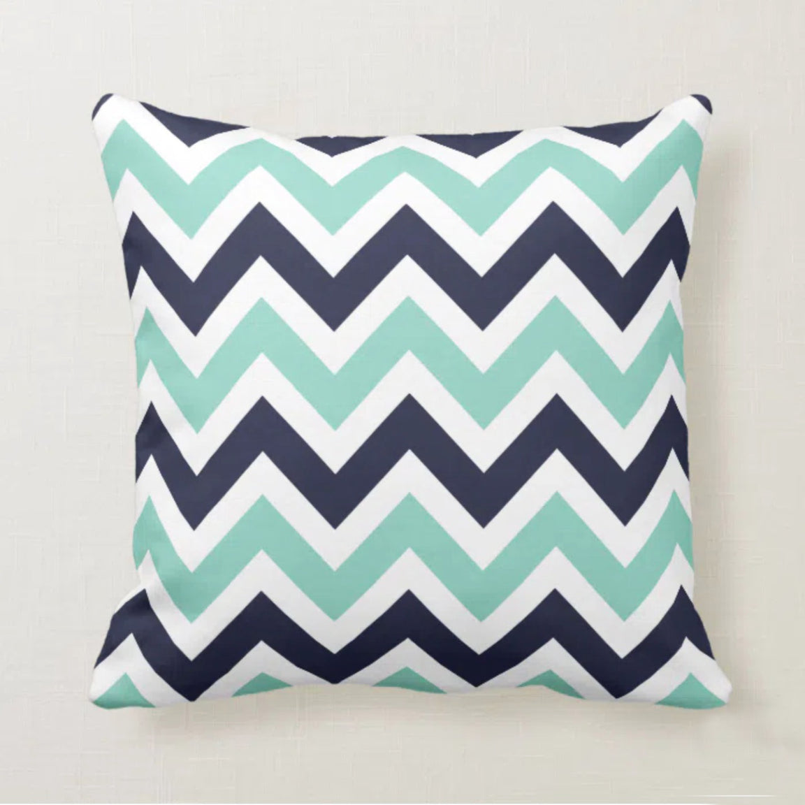 Cushion cover with navy, mint and white chevrons.