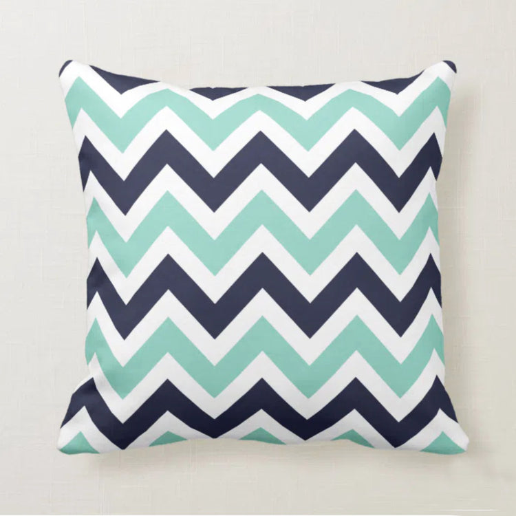 Cushion cover with navy, mint and white chevrons.