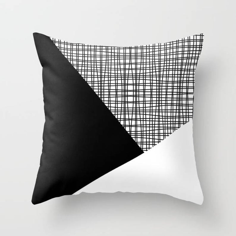 Cushion cover with black and white panels and a fine grey checked section.