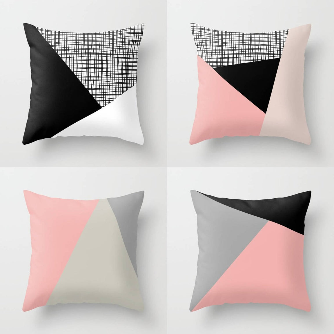 Four geometric cushion covers in blush, grey, cream and black.