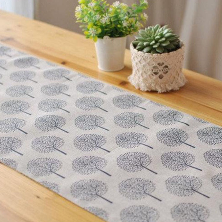 Light beige tree-pattern table runner displayed along a dining table.