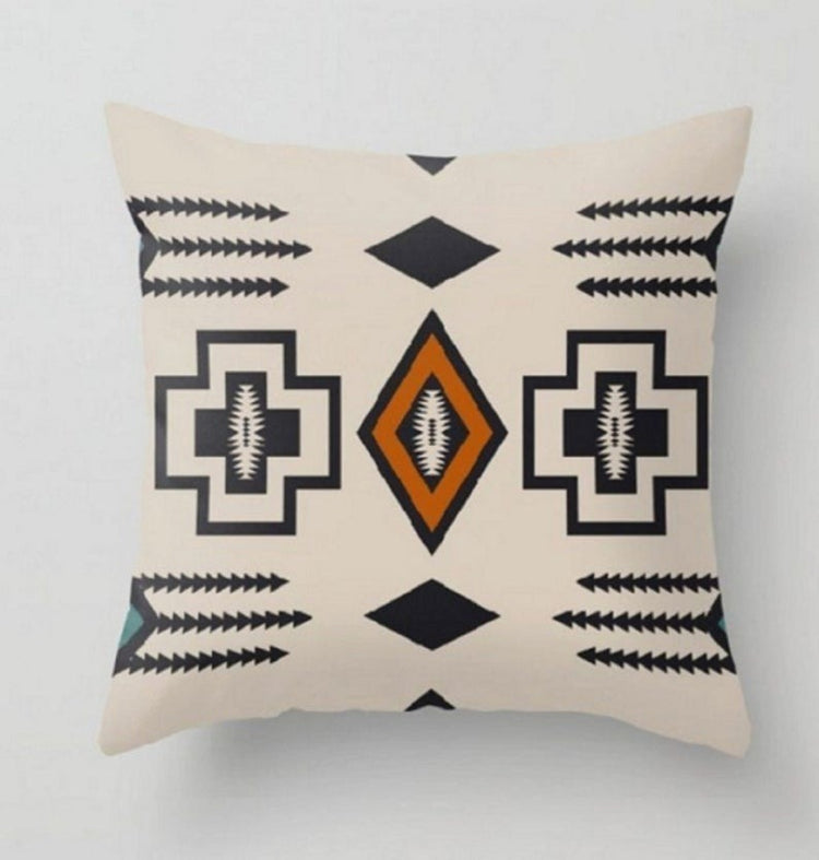 Cream cushion cover with black geometric outlines and an orange central diamond.