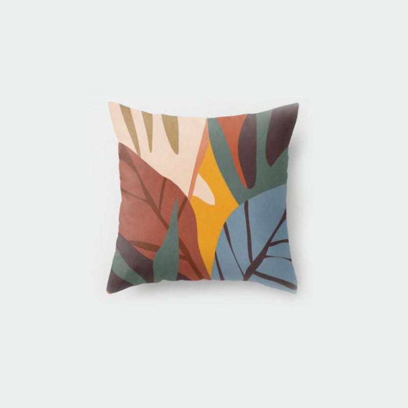 Cushion cover with abstract leaves in rust, mustard, grey and cream.