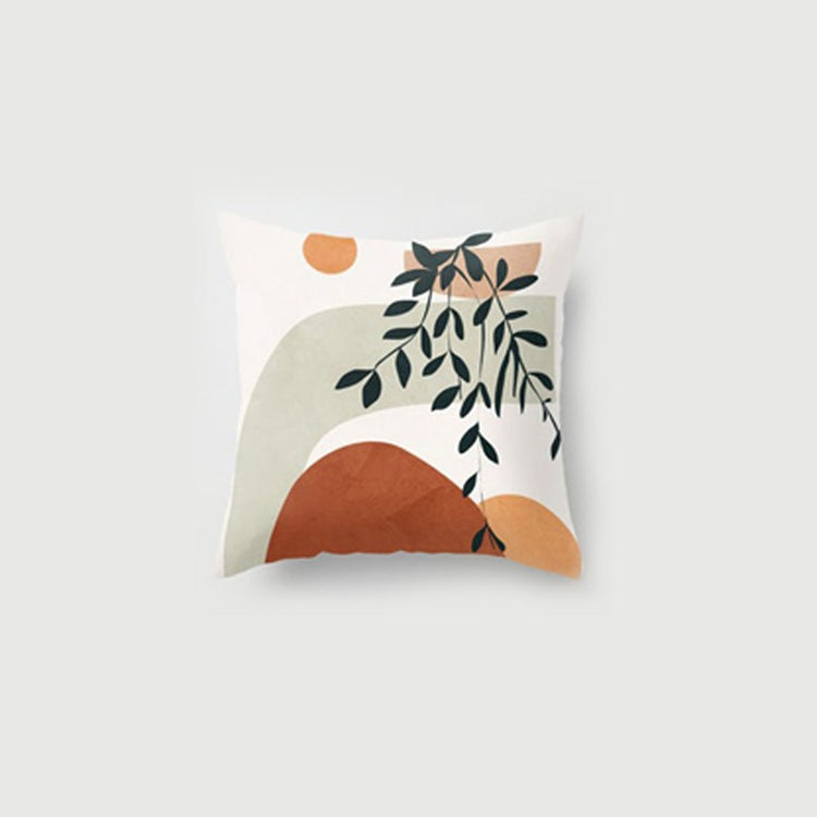 Cream cushion cover with a leafy branch and a rust-coloured semicircle.