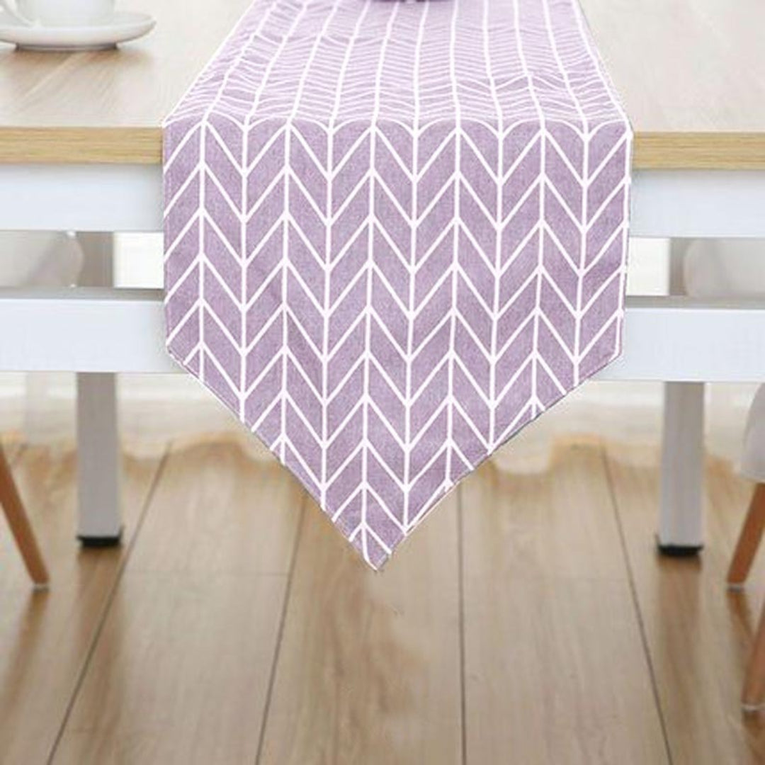 Lavender table runner with white chevron lines.