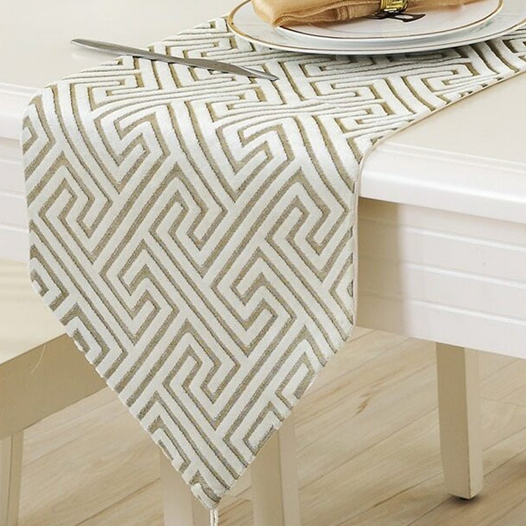 Cream and beige geometric line-pattern table runner beneath a place setting.