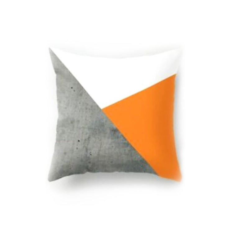 Cushion cover with large white, grey and orange triangles.