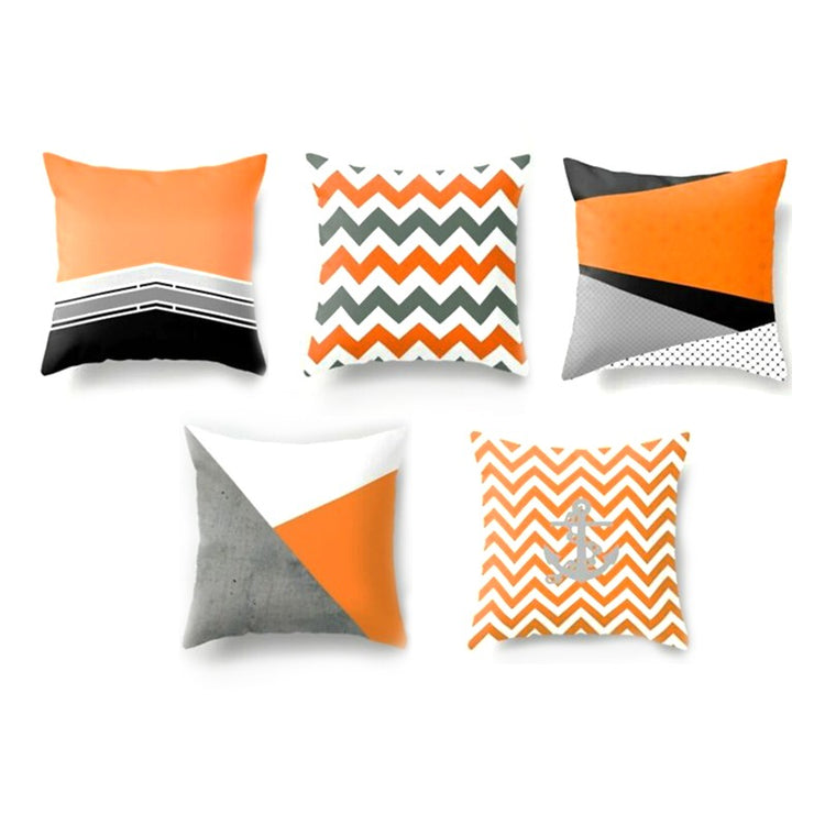 Five orange, grey, black and white geometric cushion covers.