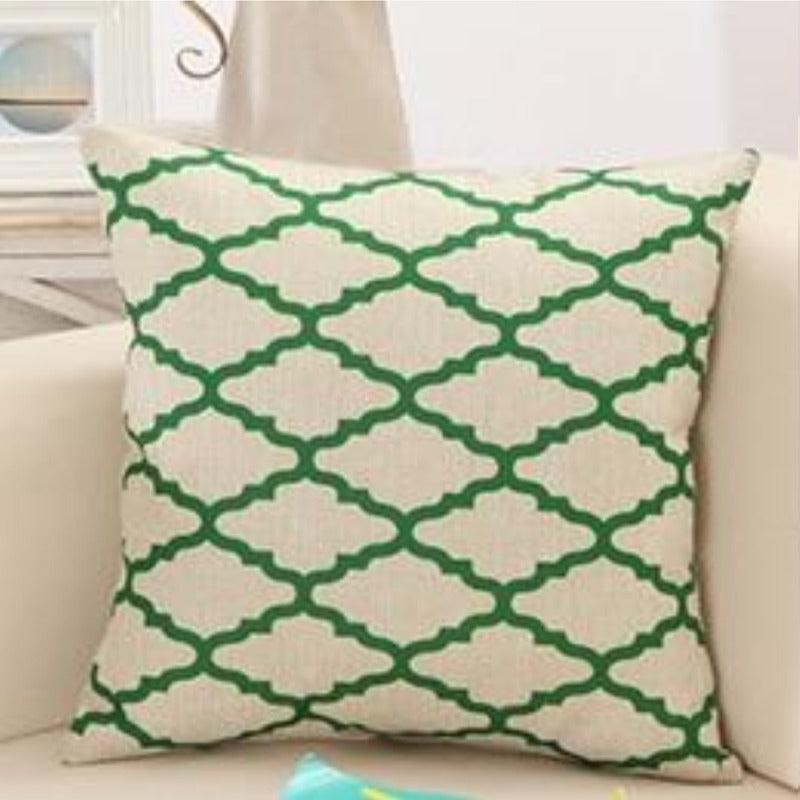 Cream cushion cover with a green interlocking lattice pattern.