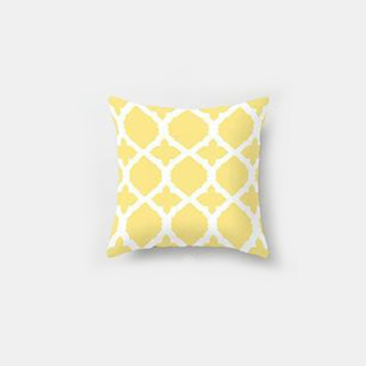 Yellow cushion cover with a white interlocking lattice pattern.