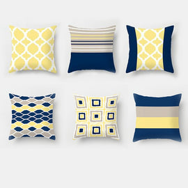 Six navy, yellow, grey and white cushion covers with assorted geometric patterns.