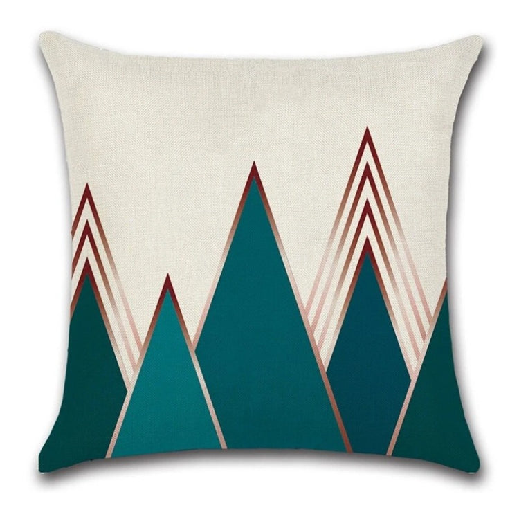 Cream cushion cover with tall teal triangles and rust outlined triangles.