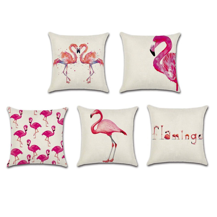 Five cream cushion covers with pink flamingo designs and lettering.