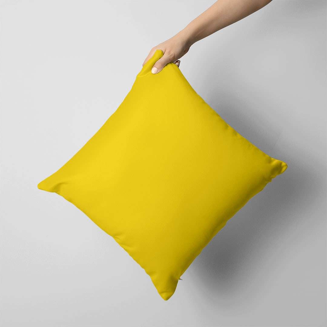 Plain bright yellow cushion cover held against a grey background.