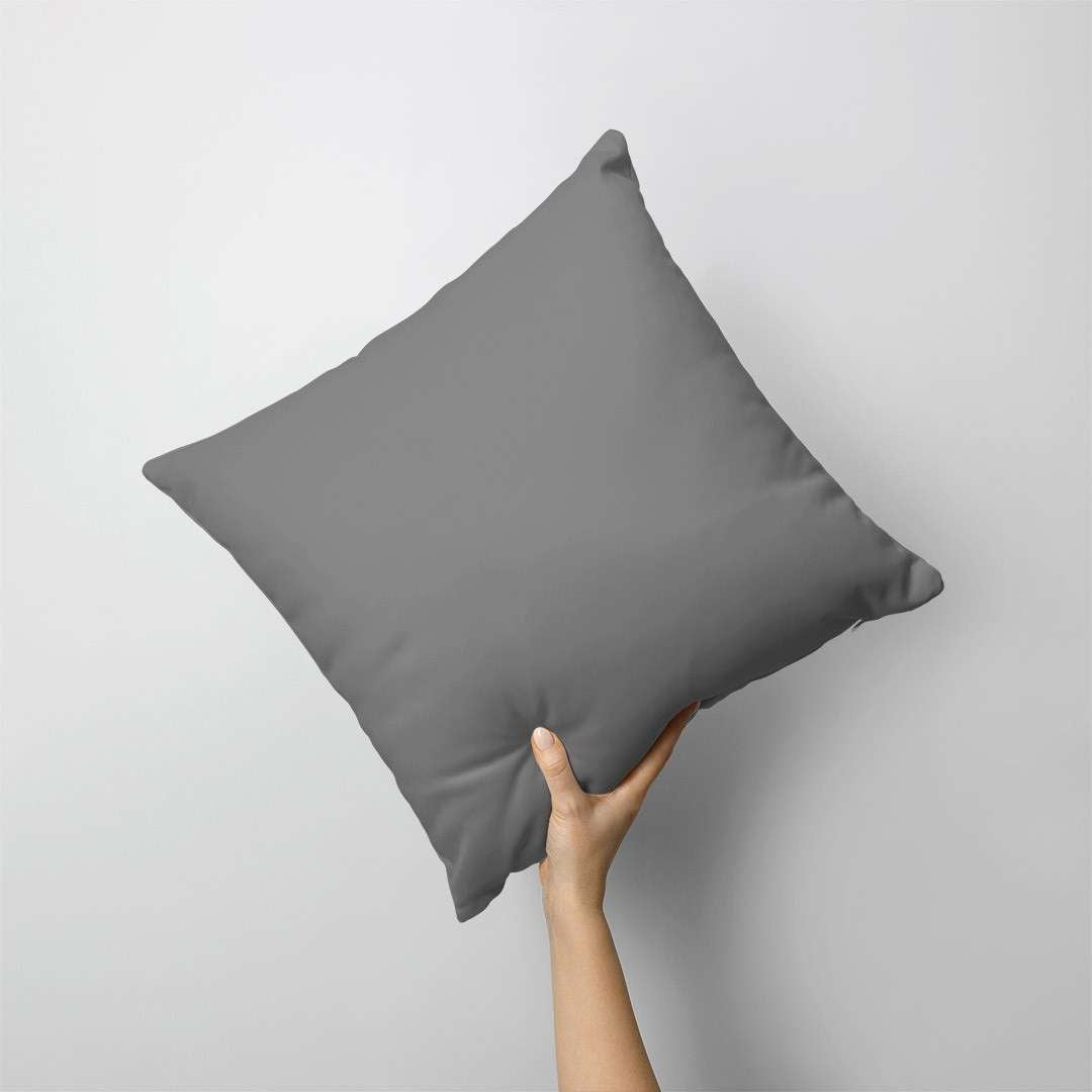 Plain dark grey cushion cover held against a grey background.