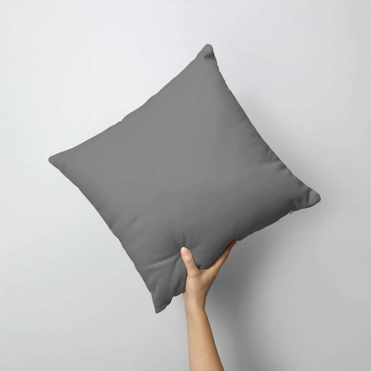 Plain dark grey cushion cover held against a grey background.