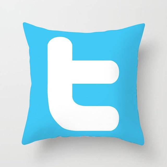 Blue cushion cover with a large white lowercase t.