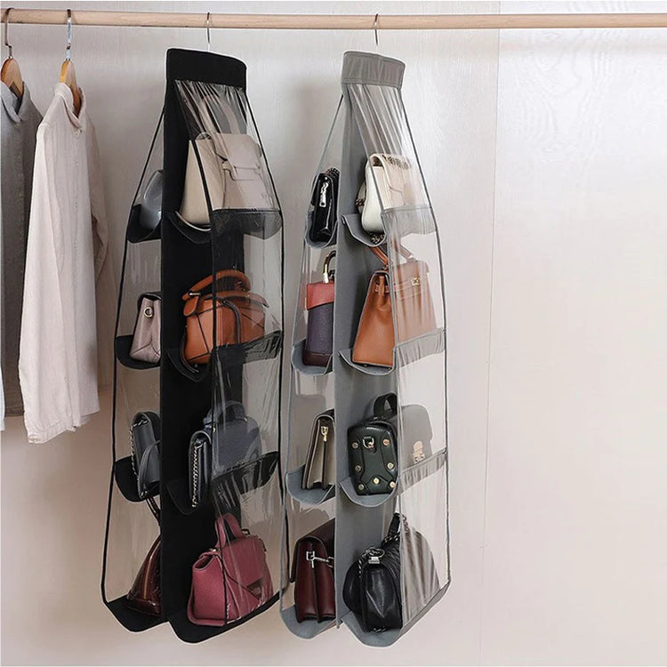 Hanging handbag organizers holding bags inside a wardrobe.