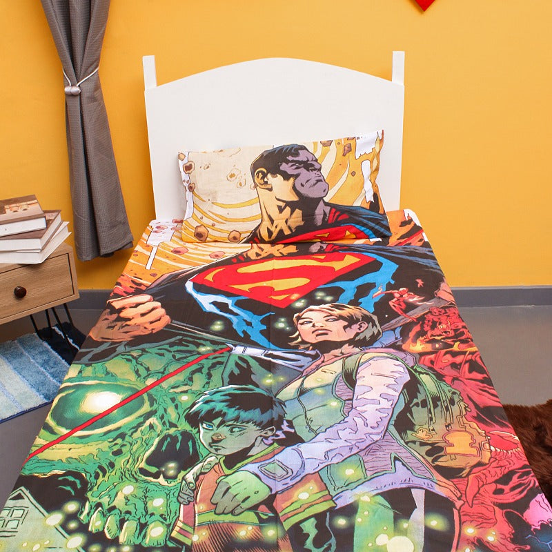 Colourful superhero-print children's bedsheet and matching pillowcase on a single bed.