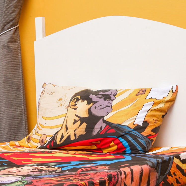 Close-up of a superhero-print pillowcase and matching bedsheet.