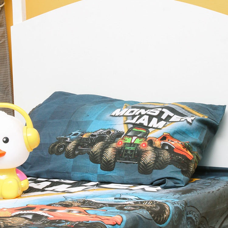 Close-up of a monster truck-print pillowcase and matching bedsheet.