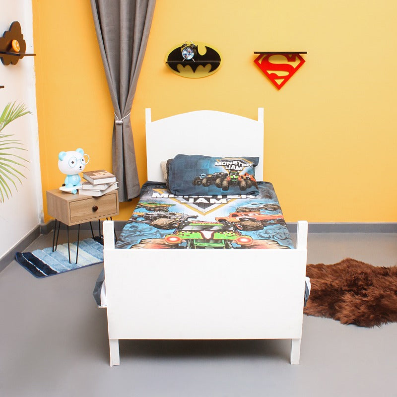 Front view of a single bed dressed in a monster truck-print bedsheet.