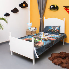 Monster truck-print children's bedsheet and pillowcase on a single bed.