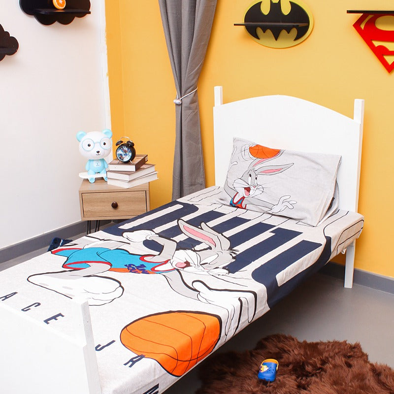 Children's bedsheet with a cartoon rabbit and basketball design on a single bed.