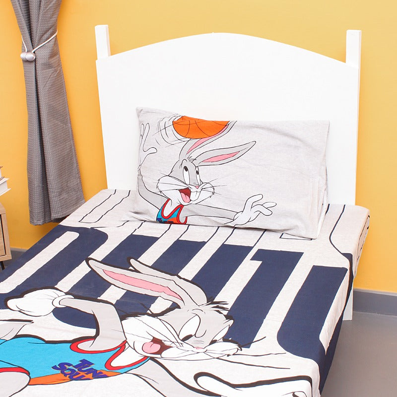 Close view of a cartoon rabbit and basketball print on a children's bedsheet.