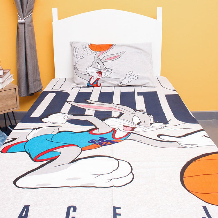 Close view of a cartoon rabbit and basketball print on a children's bedsheet.