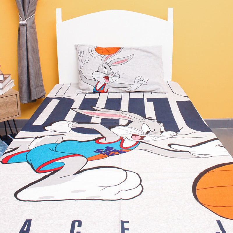 Close view of a cartoon rabbit and basketball print on a children's bedsheet.