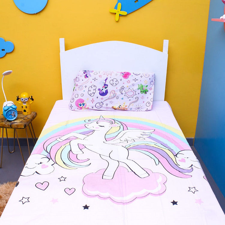 Pastel unicorn-print children's bedsheet and matching pillowcase on a single bed.