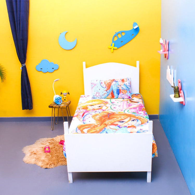 Colourful cartoon-girl-print children's bedsheet on a single bed.