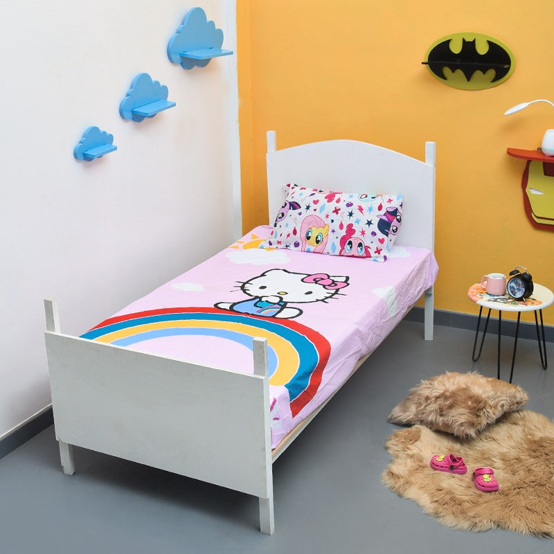 Pink children's bedsheet with a cartoon cat and rainbow design.
