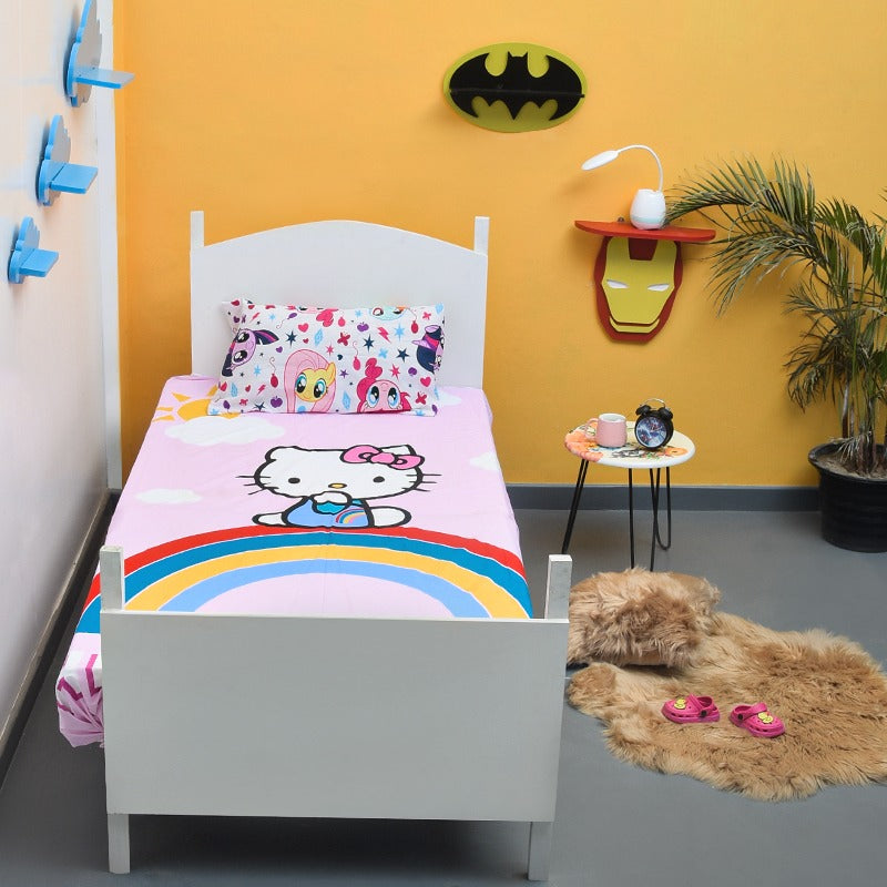 Pink cartoon-cat and rainbow bedsheet on a white single bed.