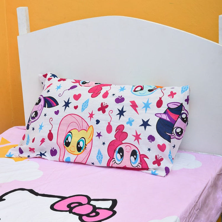 Close-up of a colourful cartoon-print pillowcase above a pink cat-print bedsheet.