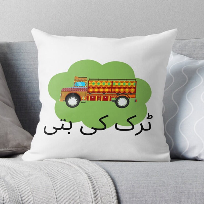 White cushion cover with a colourful decorated truck and Urdu lettering.