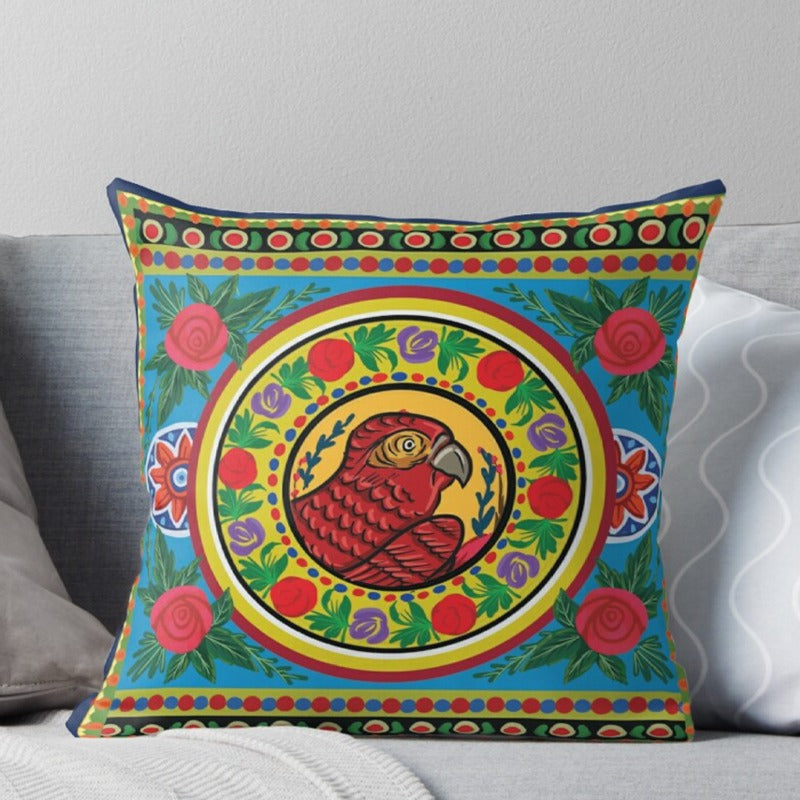 Green cushion cover with an ornate multicoloured circular motif and patterned borders.